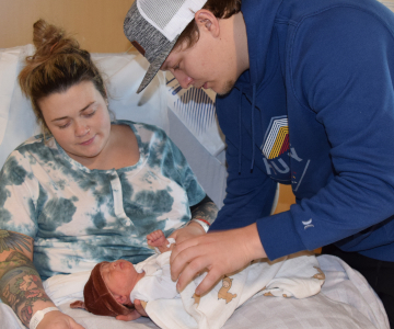 A new local baby held by her parents at Samaritan Pacific Communities Hospital.