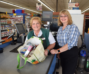 Volunteers show off groceries from the protein prescription program