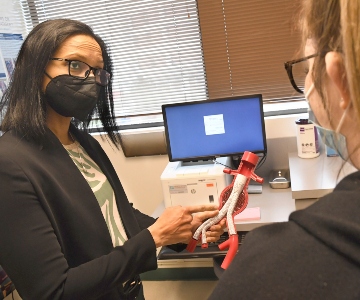 Dr. Madabhushi showing vascular model to patient