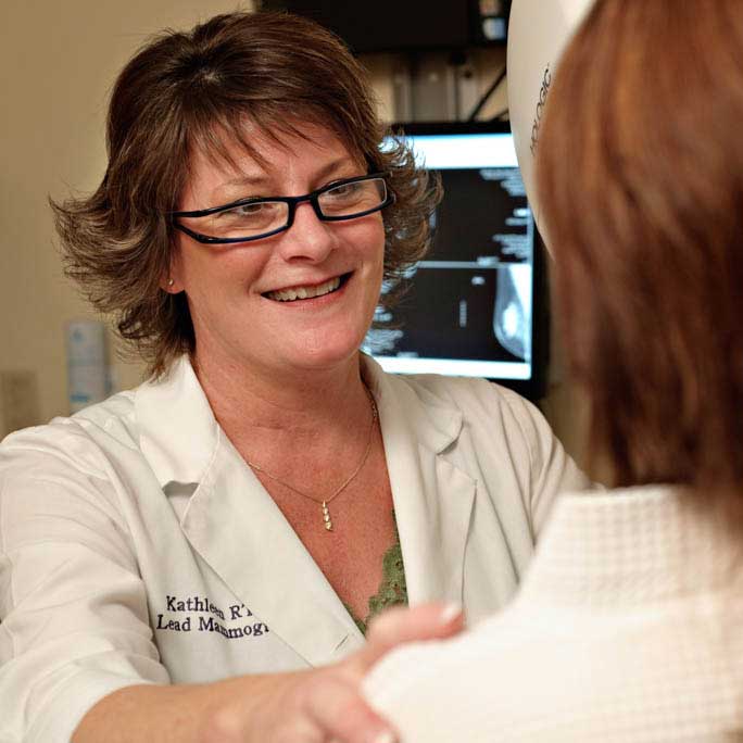 Clinician talking to a patient about imaging and mammography.