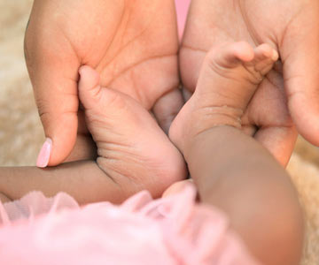 baby feet in mama hands