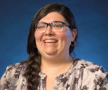 smiling young woman talking to a group.