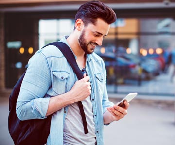 Man looking down at cell phone.