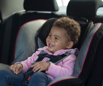 Toddler in a car seat.