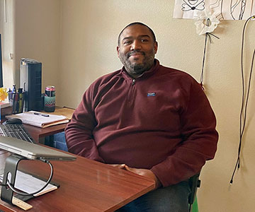 Samaritan systems analyst sitting in his remote home office.