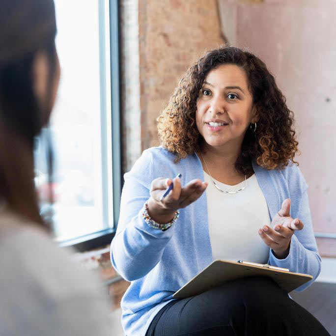 Woman counseling her patient in a one-on-one session.