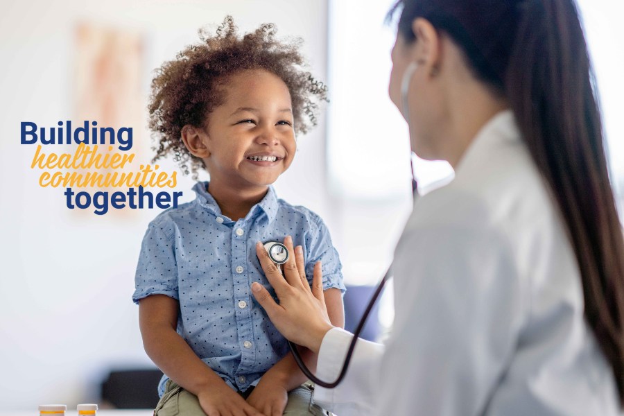 Female pediatrician listening to young boy's heart.
