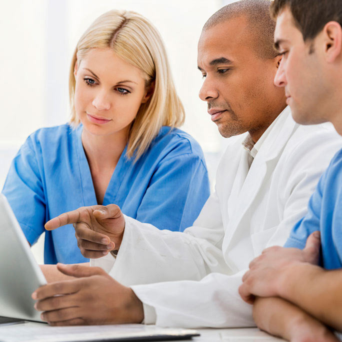medical staff looking at a computer