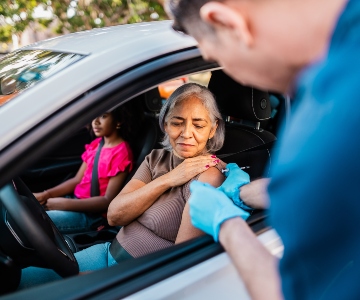Woman gets flu shot while sitting in car