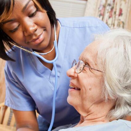 Hospice clinician checking a hospice patient's heartbeat.
