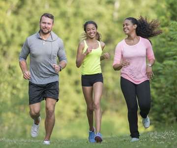 Three people running outdoors
