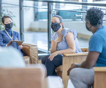 People wearing face masks in support group