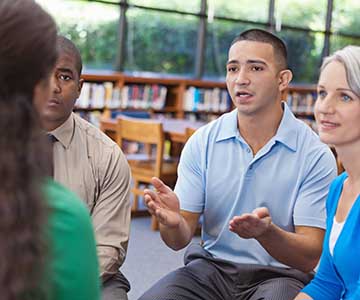adults talking in group setting