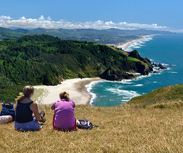 Two female hikers sitting atop Cascade Head just north of Lincoln City.