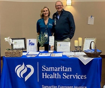 Hospice staff behind a booth at a Samaritan-sponsored event