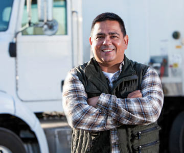 Job applicant standing in front of a box truck smiling.