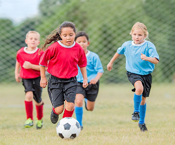 Girls and boys playing soccer.
