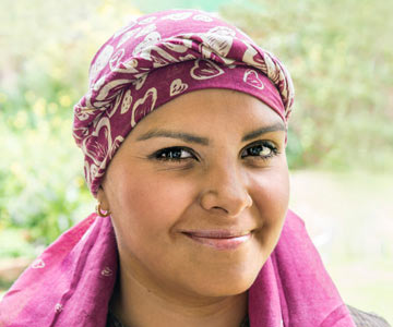 Adult black female cancer patient with head wrap covering