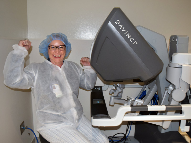 Dr. Ogden sitting at the da Vinci robot console.