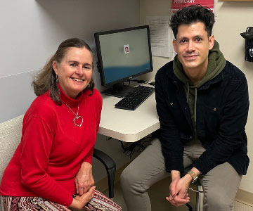 Lynn Wiles, cardiac arrest survivor, with Medical Assistant Hugo Kyriss at Samaritan Cardiology.