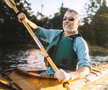 Man in a kayak on a river.