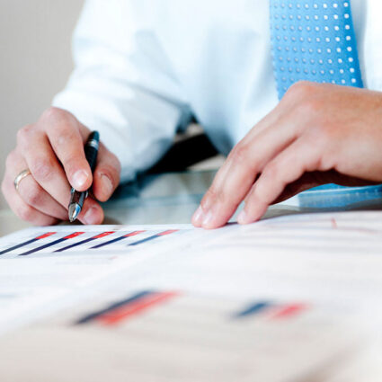 two hands with one holding pen