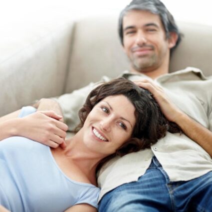 man and woman laying on couch