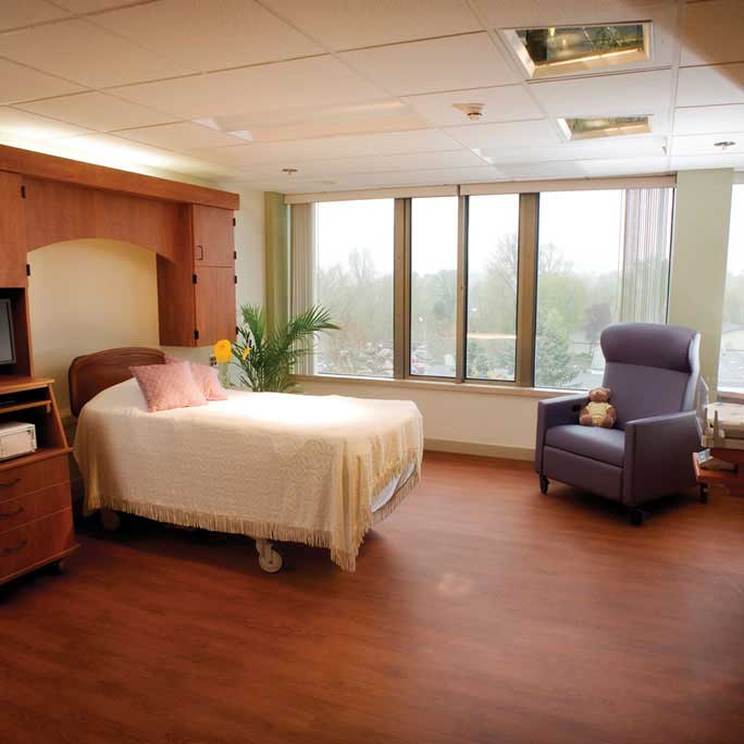 Maternity room with bed and chair at Samaritan Albany General Hospital.
