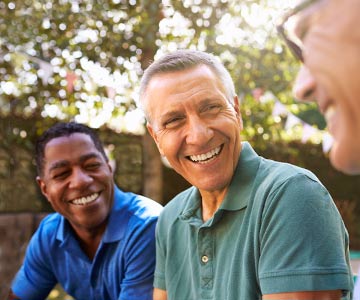 Three middle age men laughing