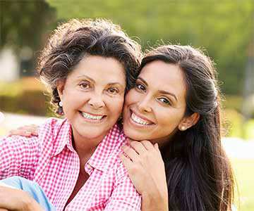 Mom and adult daughter hugging