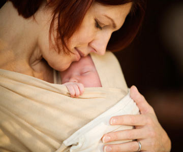 Woman holding baby in sling