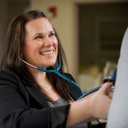Cardiac rehabilitation provider checks blood pressure.