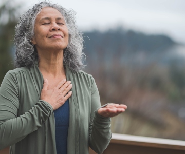 Woman at peace with eyes closed and hand on heart