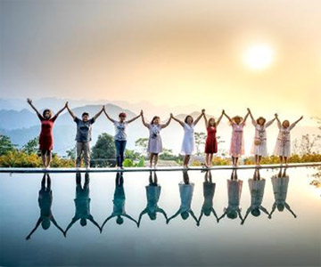 A group of people holding hands with arms raised in unity