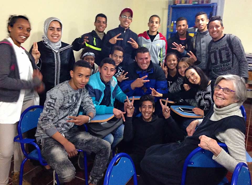 A smiling Alice with students in Morocco where she volunteered with the Peace Corps.