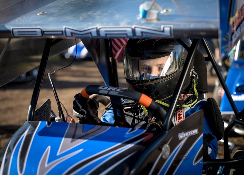 Close up of Brody with his helmet on as he sits in his race car.