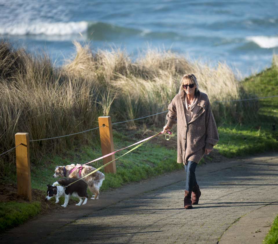 Cyndee walking her dogs up the walkway from Nye Beach in Newport, Oregon.