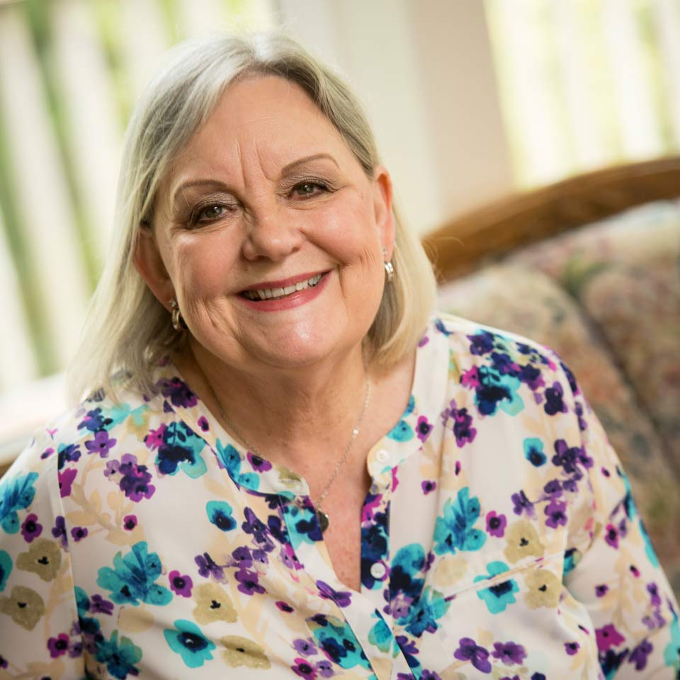 Close up of a smiling Donni looking directly at the camera.