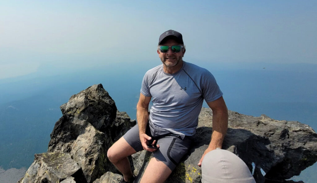 Kent sitting at the top of Mt. Thielsen in Southern Oregon.