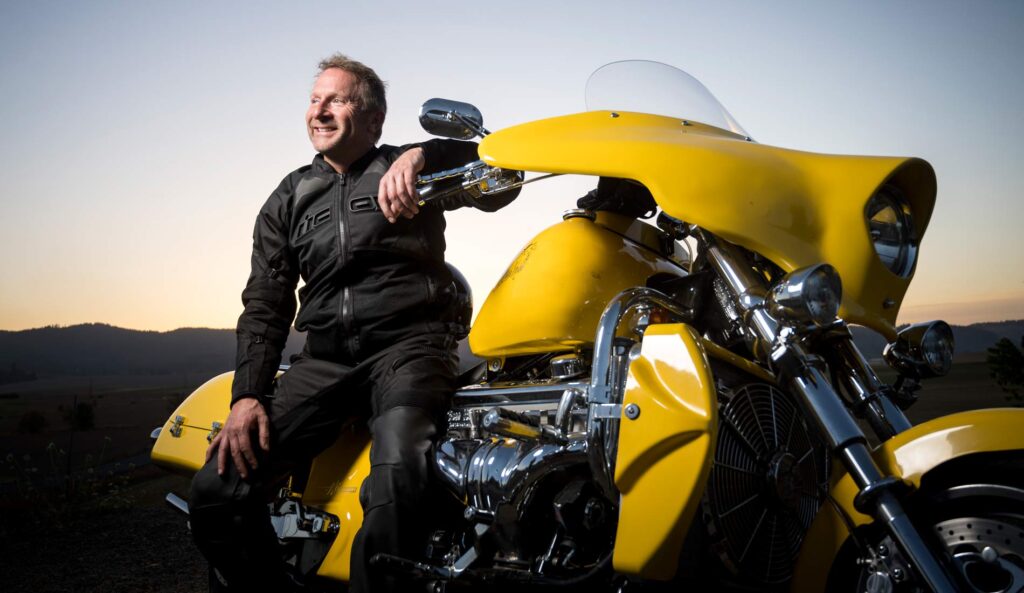 Kent in his riding gear sitting on his motorcycle.