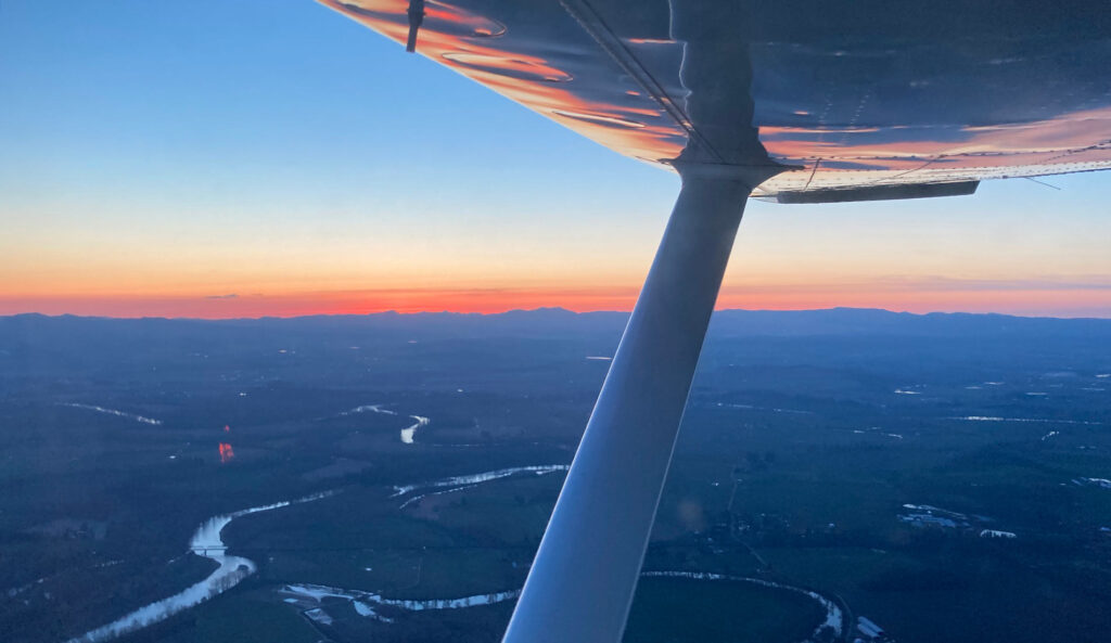 A view from Kent's plane as he flies above a local river.