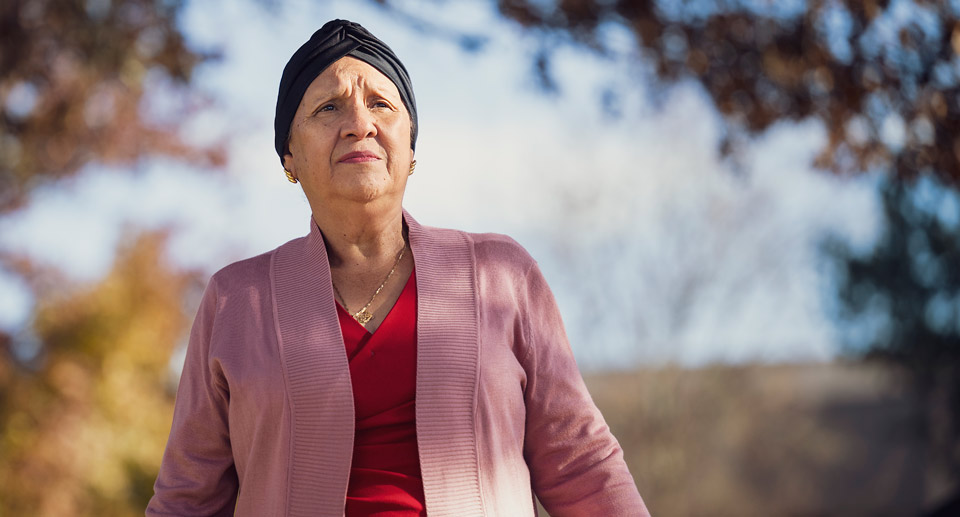 Maria, thankful for life, gazes into the distance on a walk. Walking was therapeutic to her during her treatment.