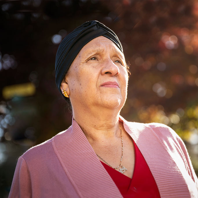 Cancer survivor thankful for life, gazes into the distance.