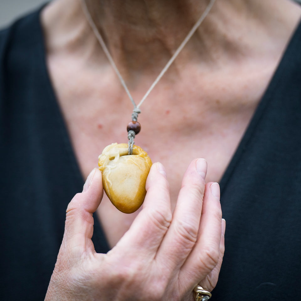 Marilyn holding a heart pendant to remember all that she has overcome.