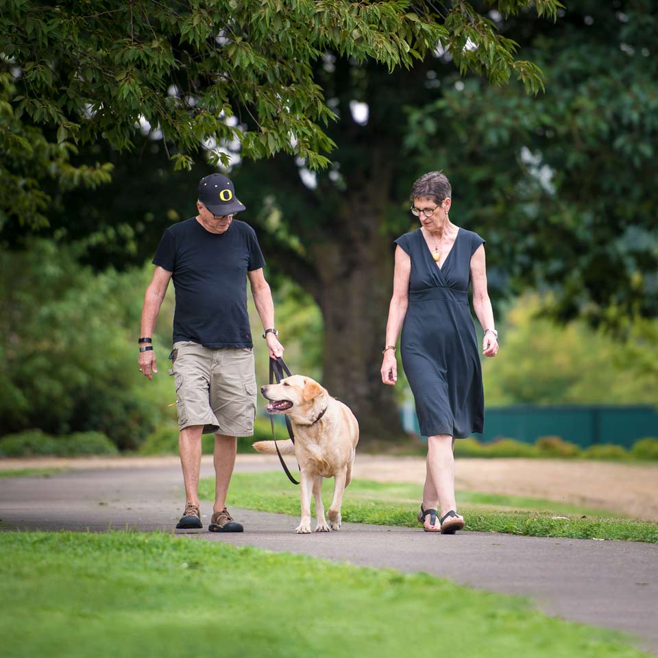 Marilyn walking with her husband and their family dog.