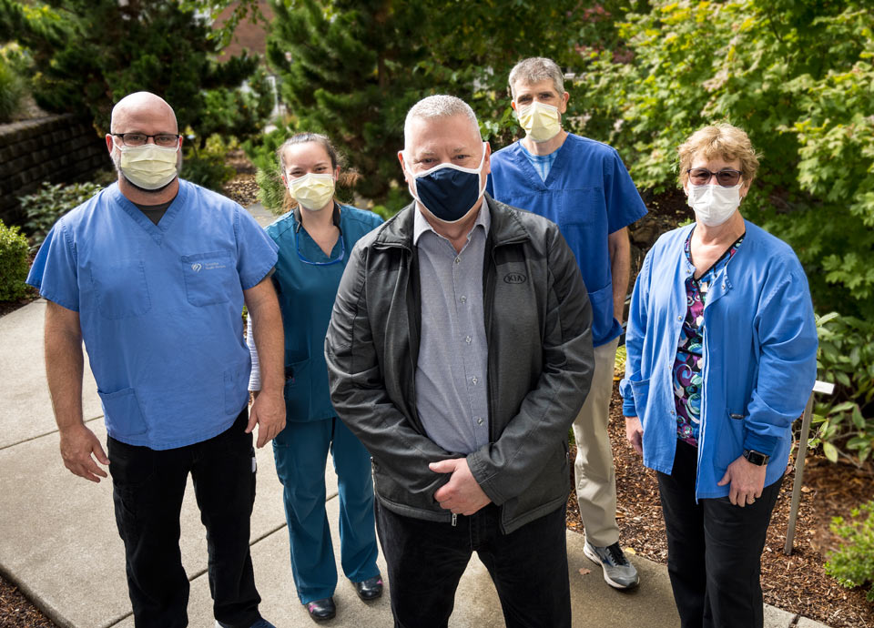 Matt at his team of caregivers at Good Samaritan Regional Medical Center. They are wearing masks.