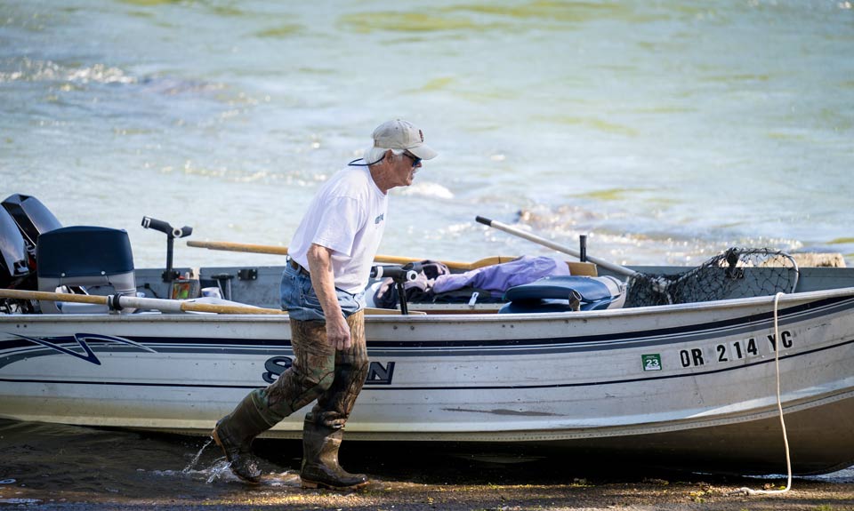 Randy alongside his boat on the Willamette River.