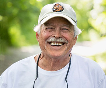 A smiling Randy standing outdoors.