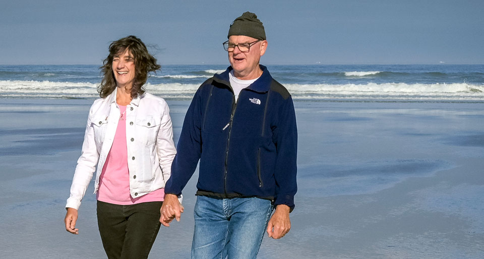 Sonia and her husband walking together at Nye Beach in Newport.