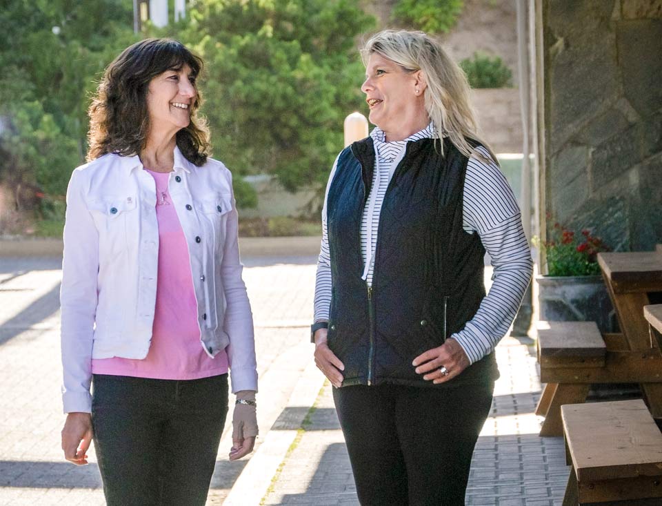 Sonia and Jeanette walking down the street together in Newport.